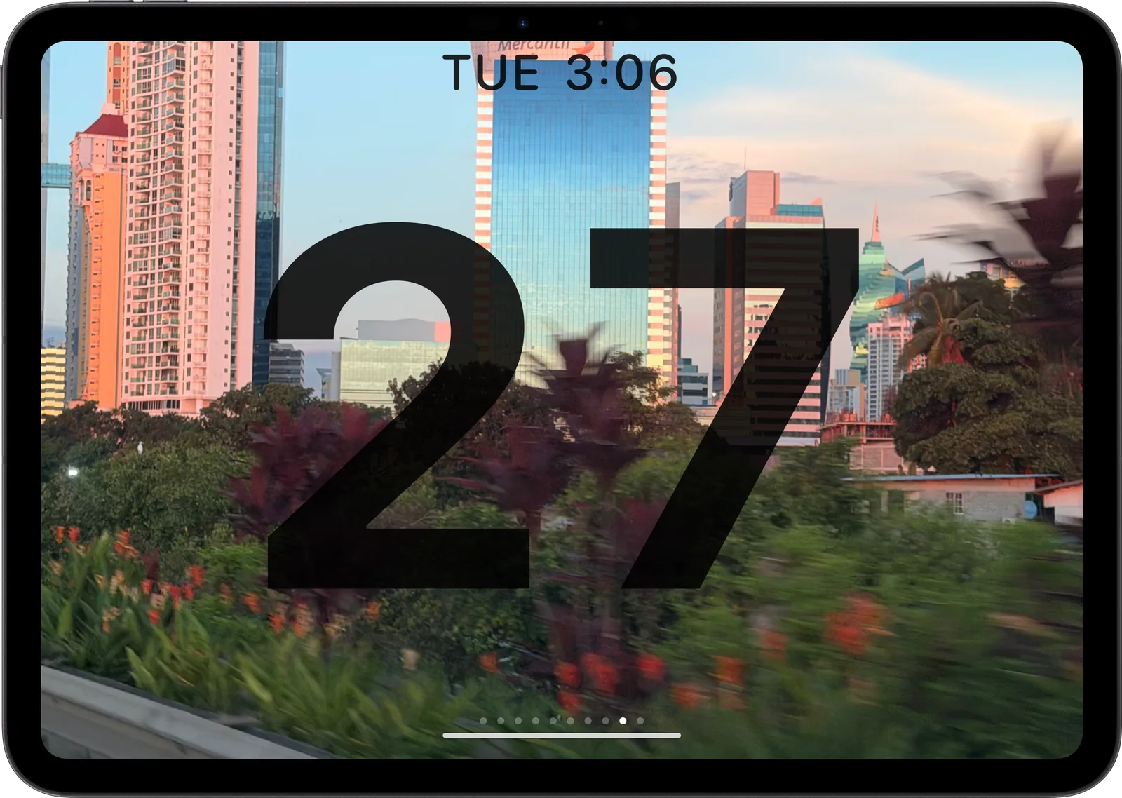 Date face: a huge 27 over a city photo